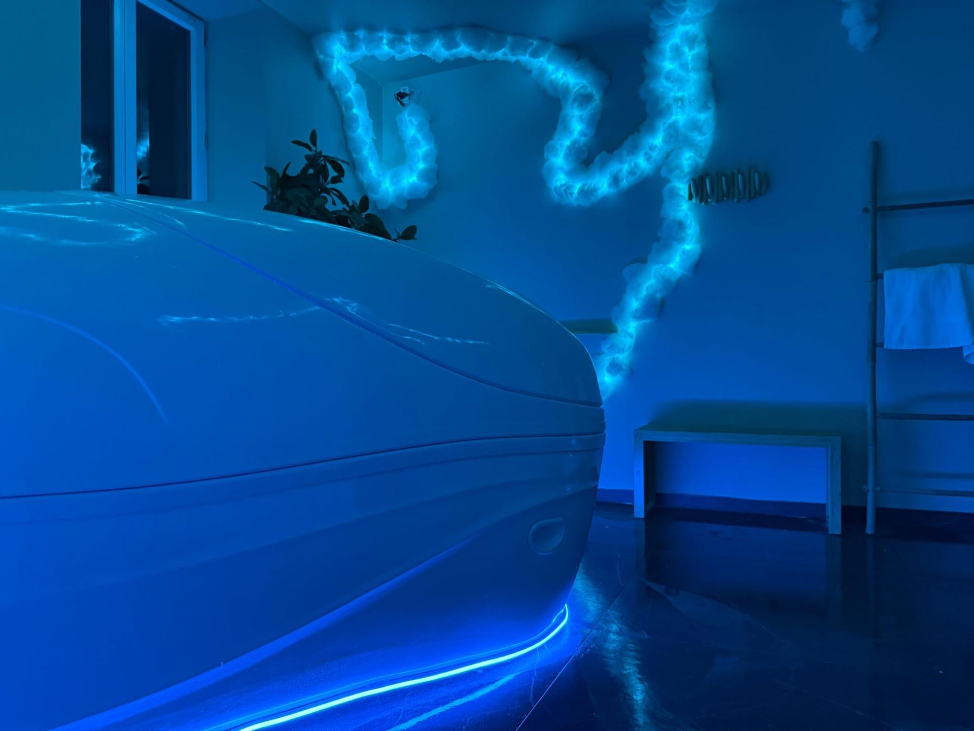 Caisson de flottaison fermé dans une salle illuminée en bleu — Serenity Sphere Metz